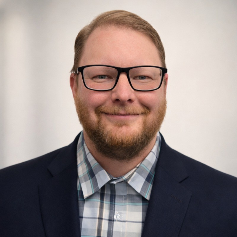 William Fenyes wearing glasses and a blazer